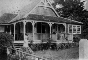  A young woman in the garden of 45 Riverview Terrace, Indooroopilly, c. 1900. State Library of Queensland, negative number: 35317